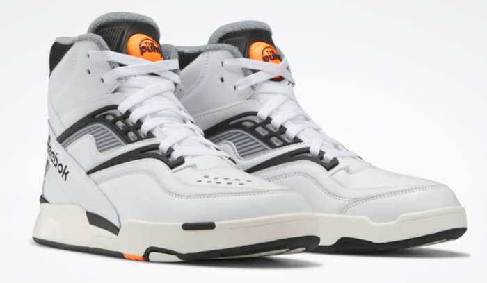 View of white and black Reebok shoes.